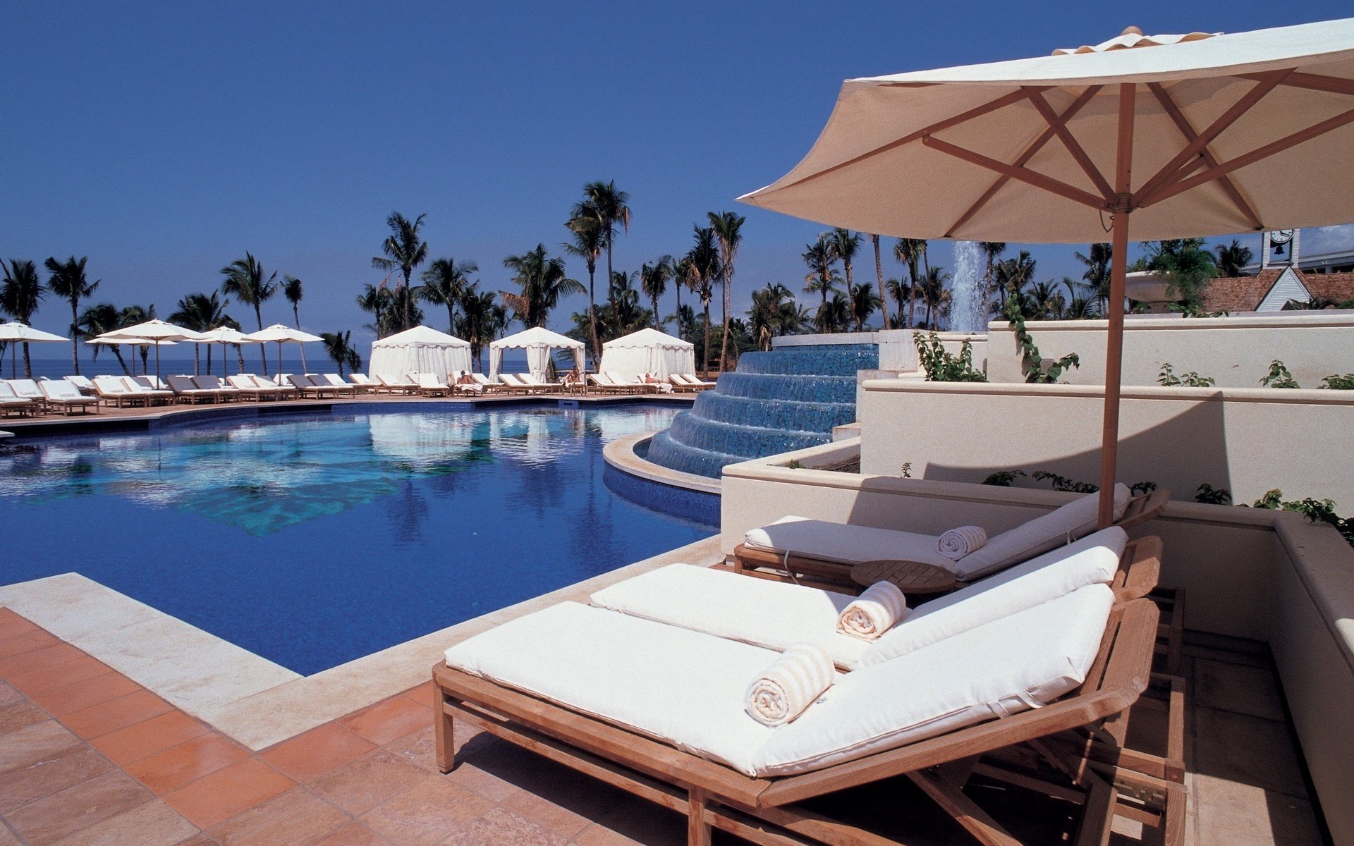 ultry sky sun beds umbrellas pool water sky resort recreation sun beds palm trees tropics fountain hotel summer heat blue sky heat