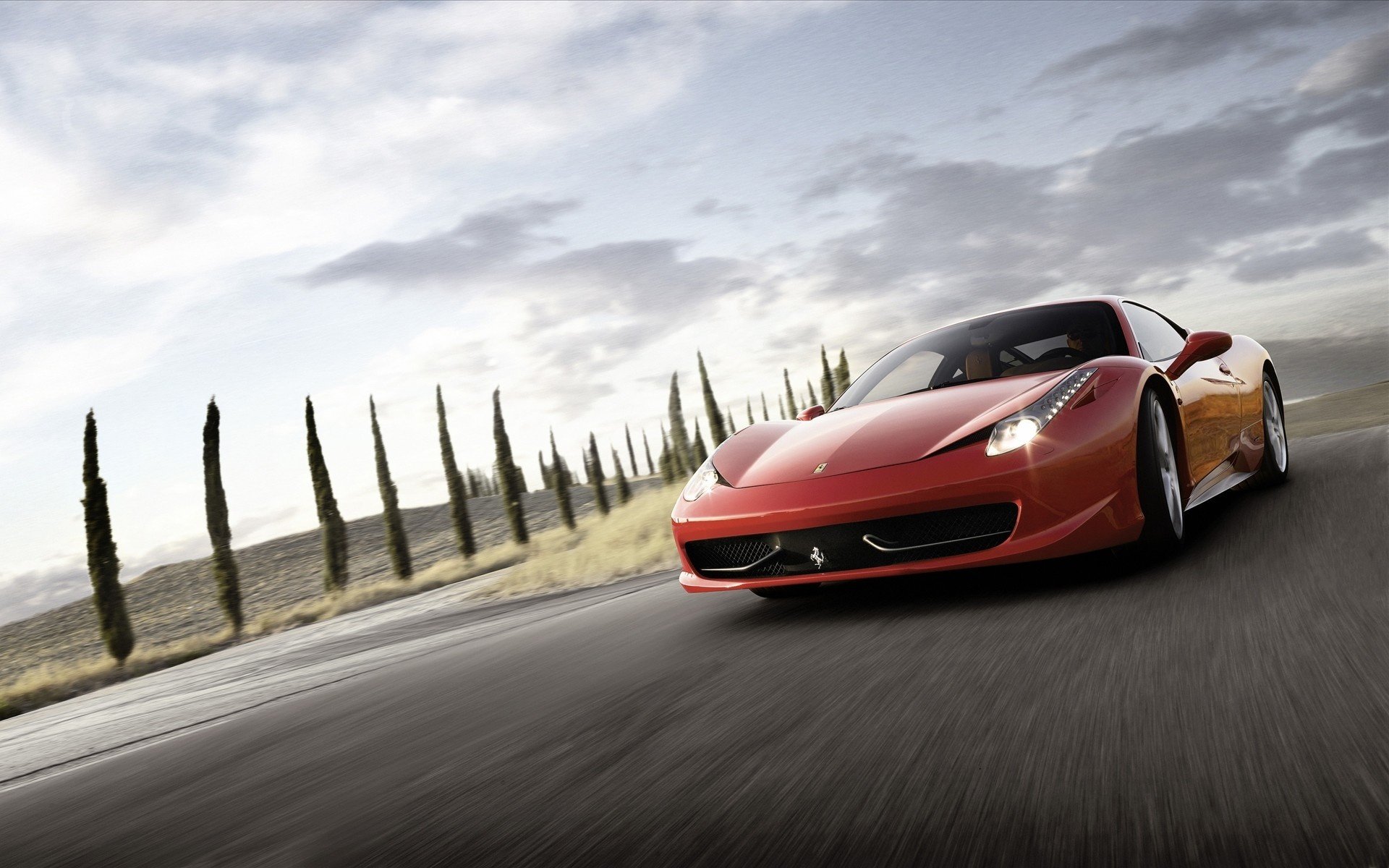 ferrari 458 at speed racing down the road auto speed movement red car road lights ferrari sports car transport vehicles trees clouds asphalt the sky drive