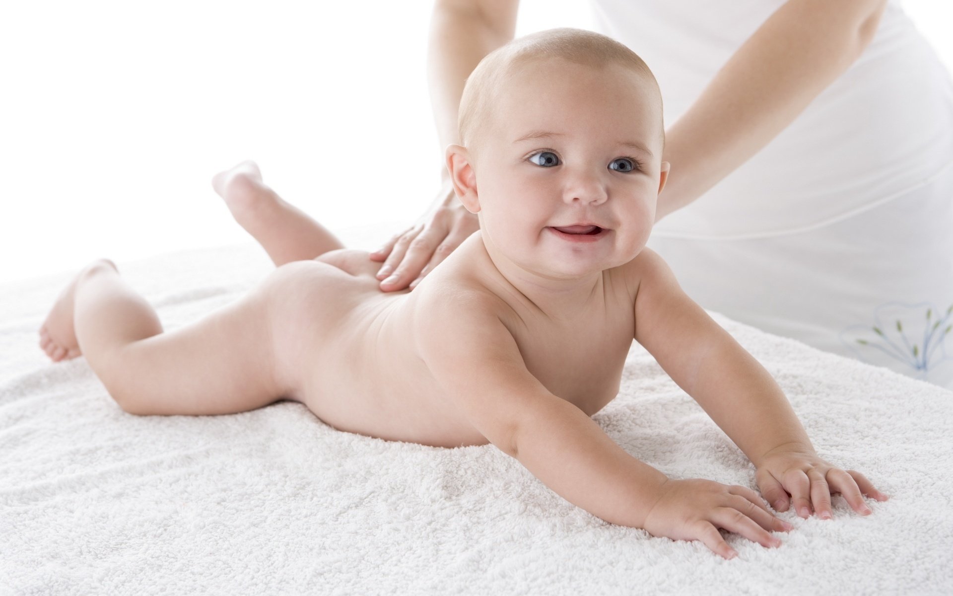 lying on the tummy baby smiling look smile eyes face joy happiness baby miracle massage