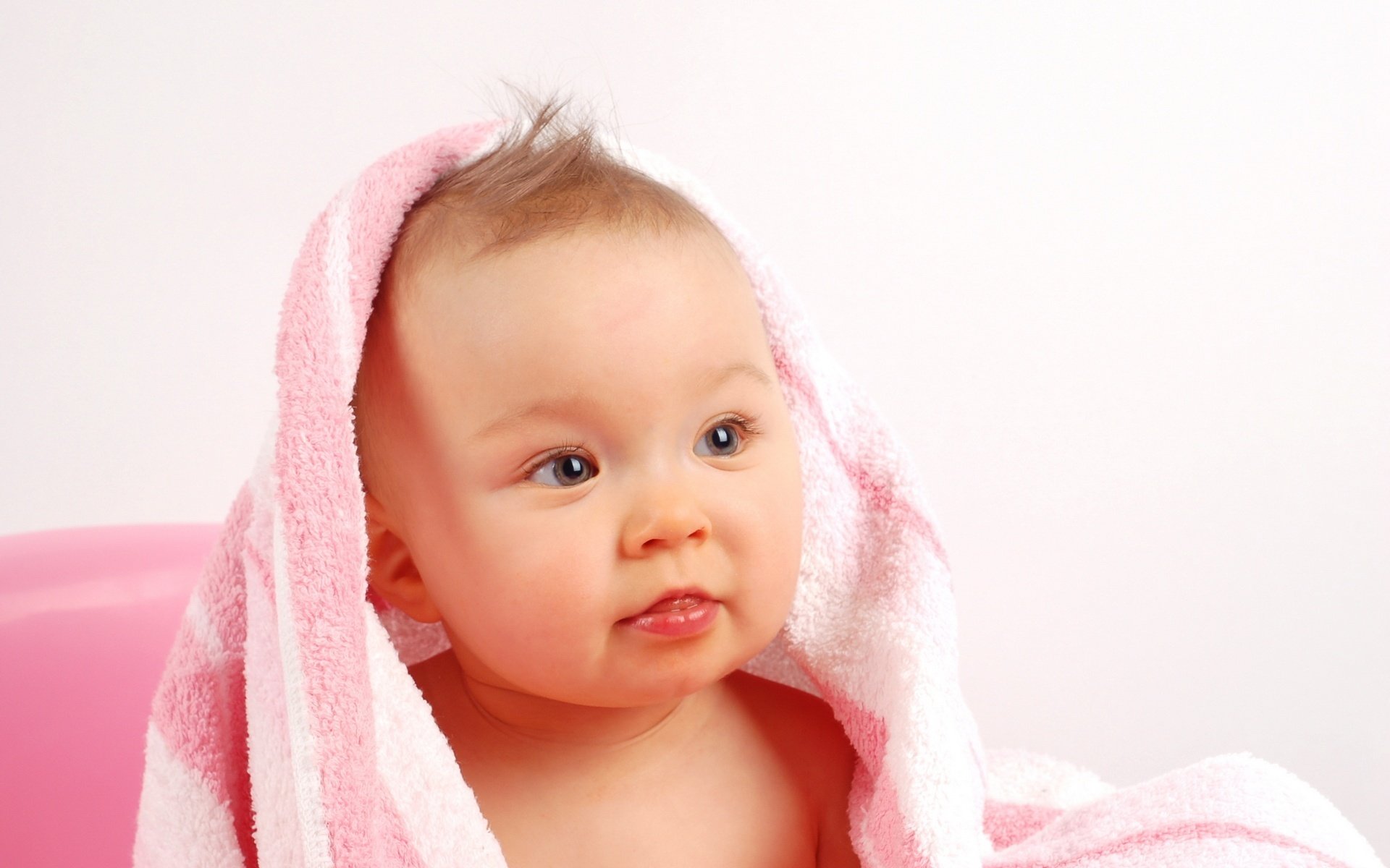 pink towel baby snub nose portrait look eyes face