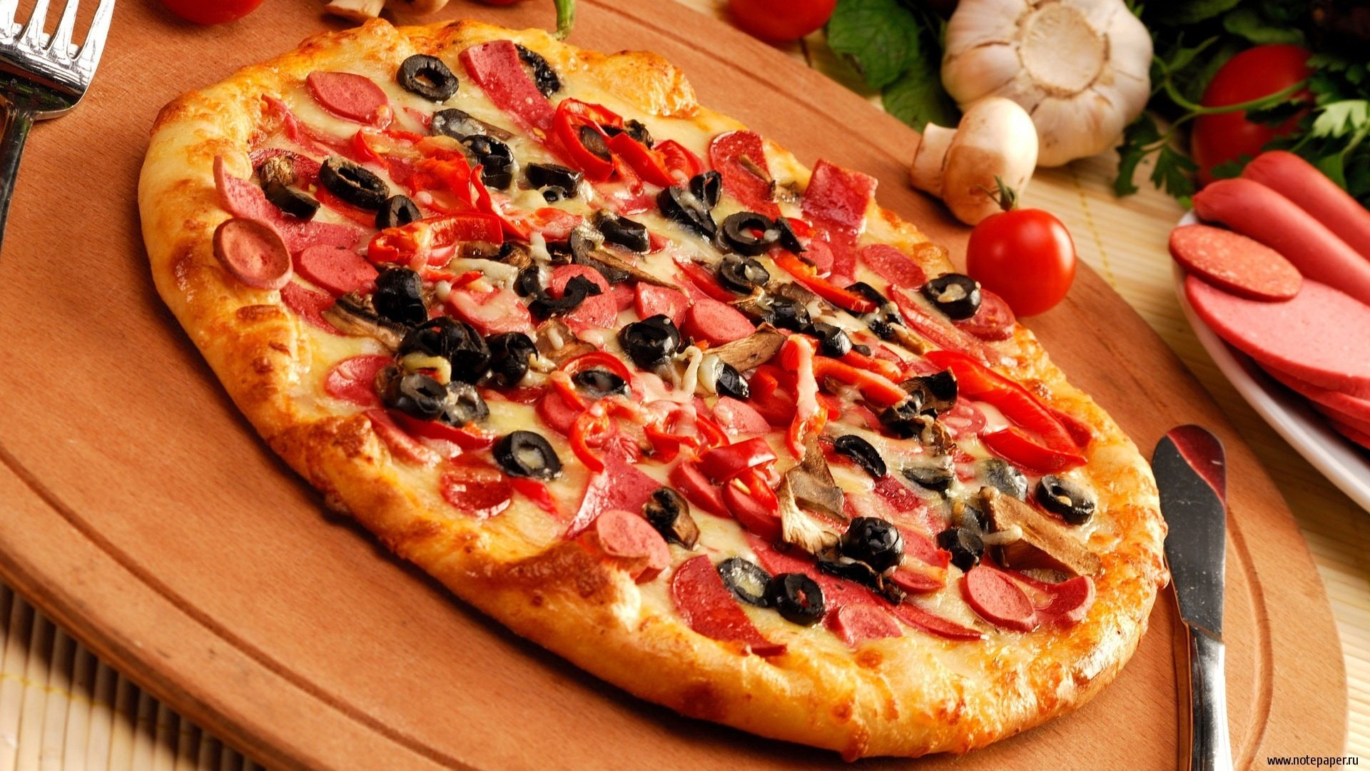 food photo dough pizza sausage garlic corner olives table board knife seasonings pizza tomatoes olive