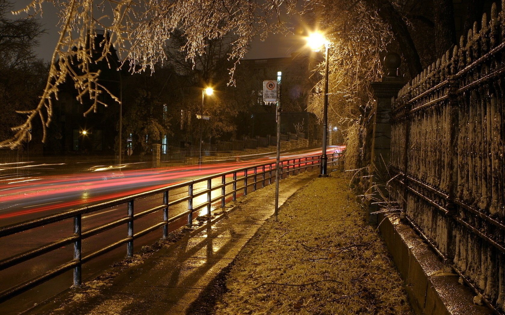 titching ver road city street the lights of the city. night lights fence light turn the fence the sidewalk lantern tree parkan branches the evening