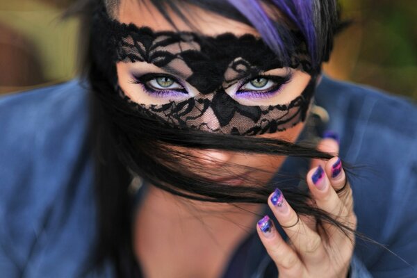 Beautiful girl in a black mask