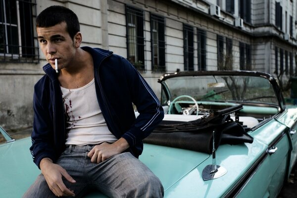Actor Mario Casas sits and smokes in the car