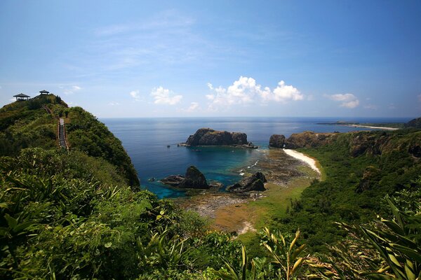 A green beach among rocky shores