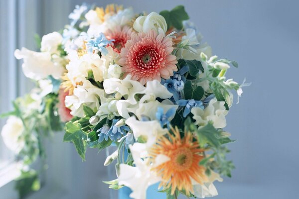 A luxurious bouquet of flowers by the window