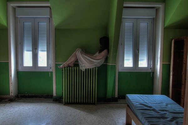 The girl in the green room is sad