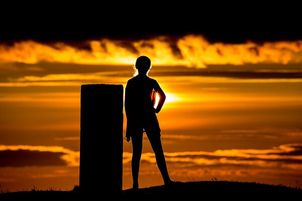 Silhouette of a girl at sunset