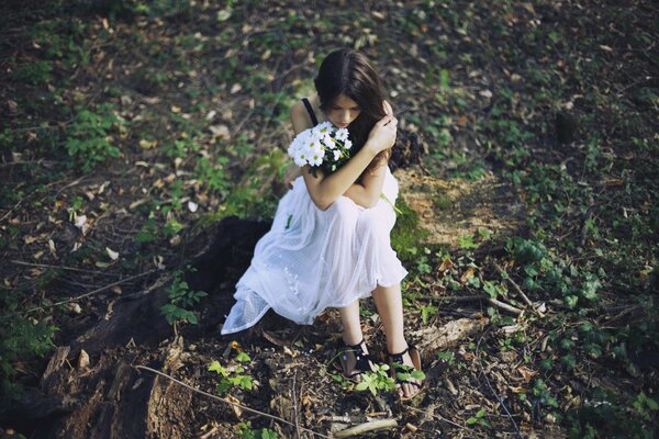 A girl in a white dress in the forest