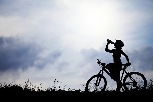 A girl in nature on a bicycle