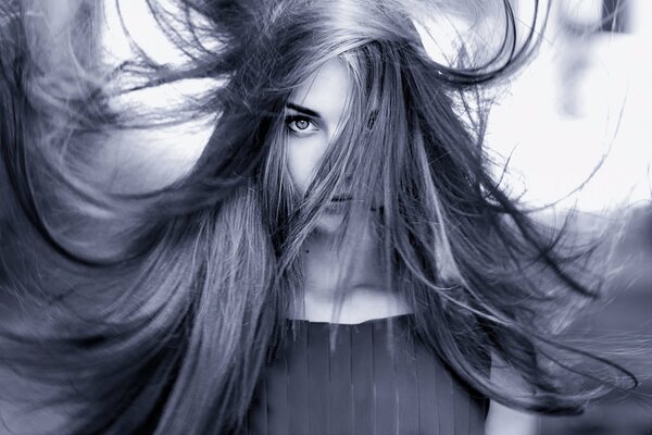 A girl with long hair looks at the camera