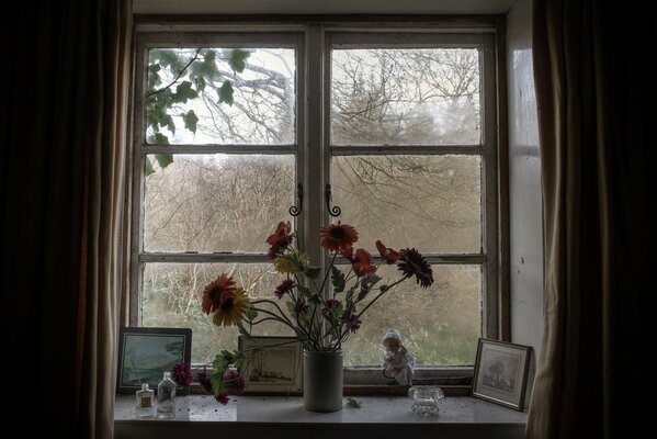 A house in the village. Vase with flowers