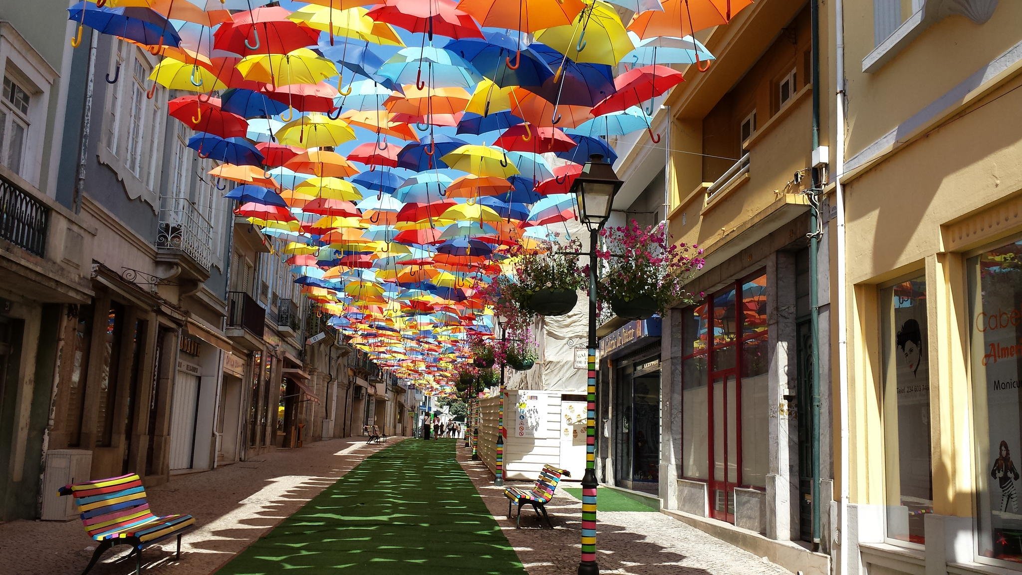 portugal town house street umbrellas summer