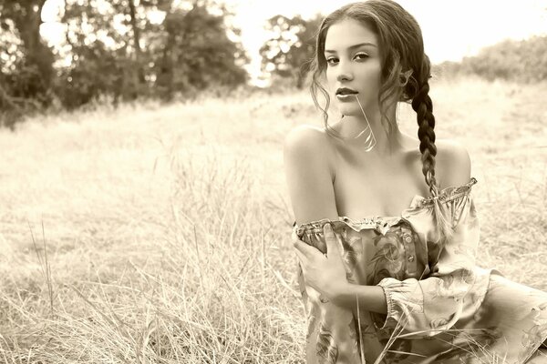 Black and white photo of a girl in the field
