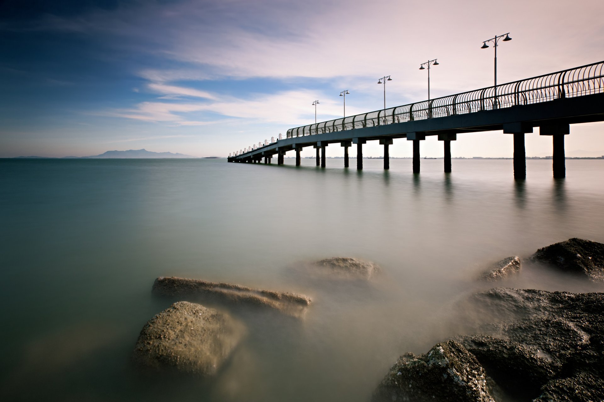 malaysia morning calm sea bridge pier beach stones sky cloud