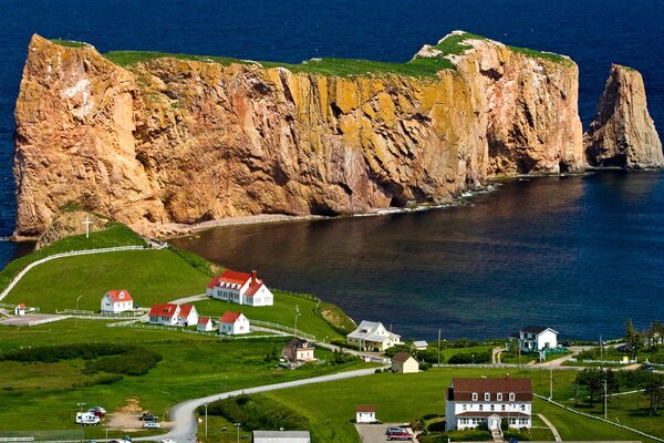 Houses by the sea on the background of rocks